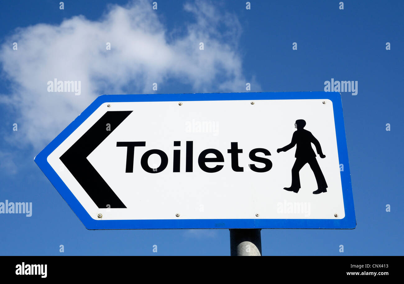 a direction sign for gentlemens toilets Stock Photo