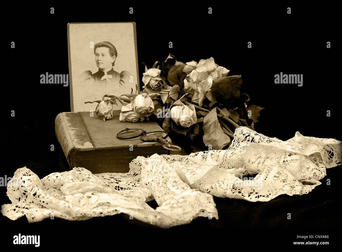 Victorian, sepia, 'in memoriam' image of a photograph of the deceased, flowers, bible and other items Stock Photo
