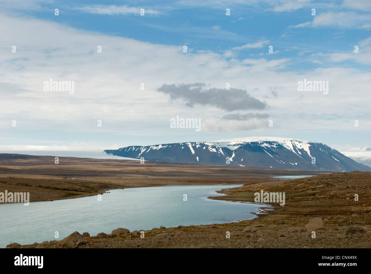view over vast scant plain with glacier lake, mountain range and glacier Langjoekull in the bachground, Iceland Stock Photo