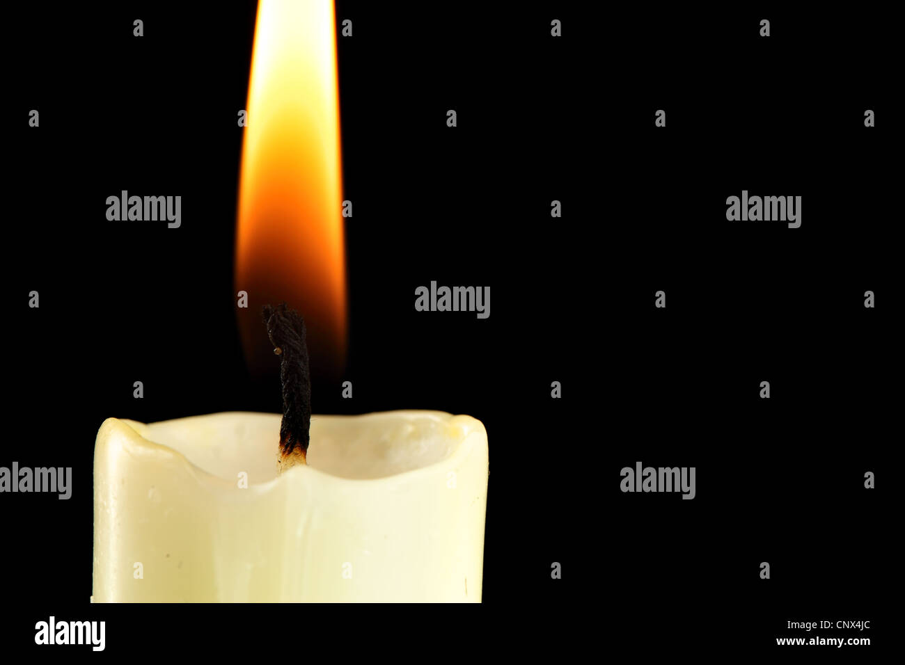 Burning candle close-up over black background Stock Photo - Alamy