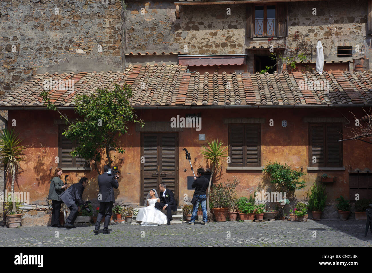 Wedding party making photographs at square of Ostia in Italy Stock Photo