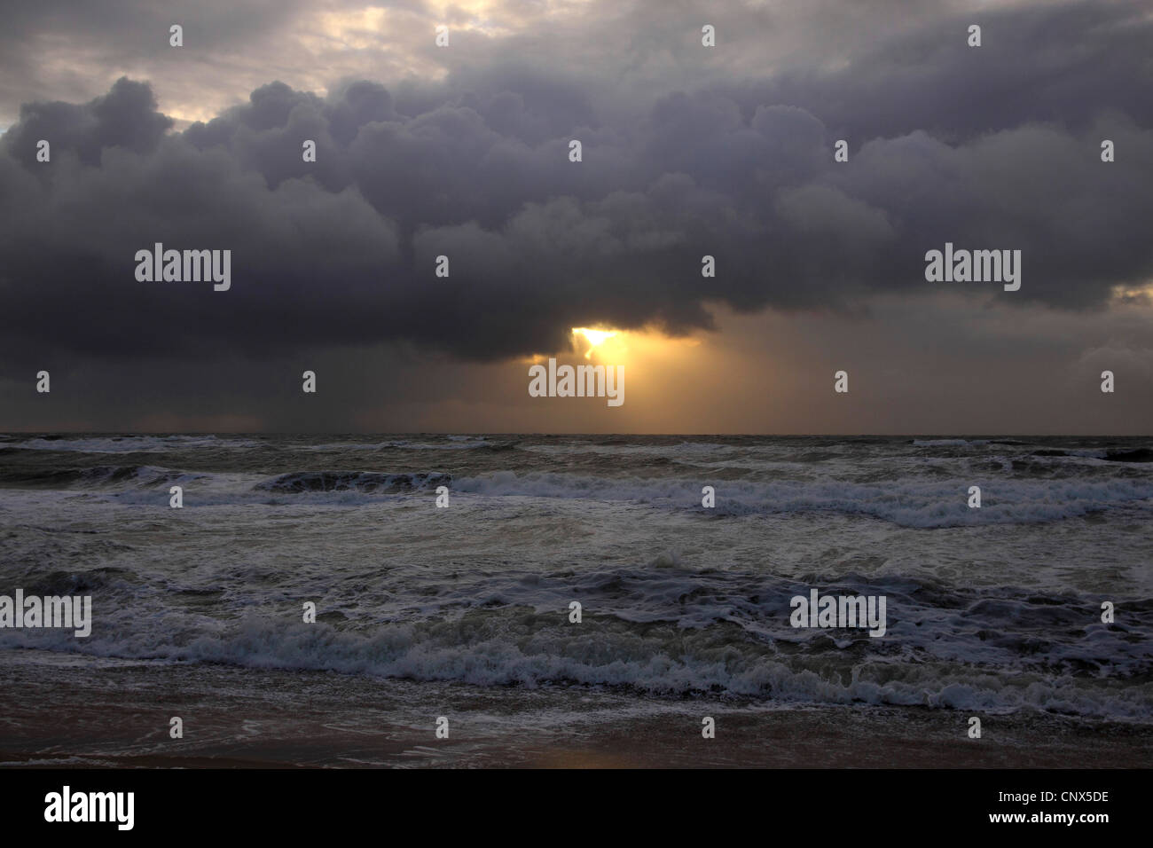 sun beam breaking through rain clouds over the North Sea, Germany, Sylt, Rantum Stock Photo