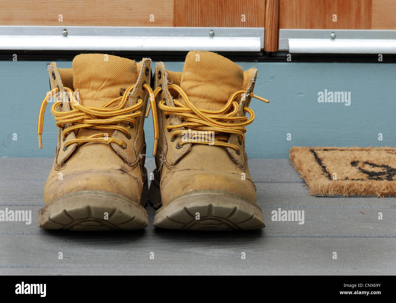 Old work boots on a porch. Stock Photo