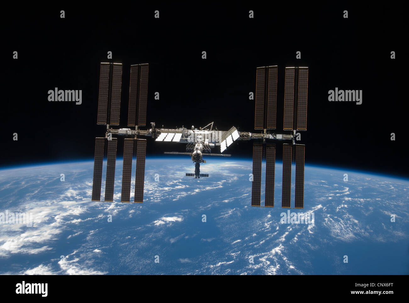 International Space Station, back dropped by space and Earth's horizon. Stock Photo