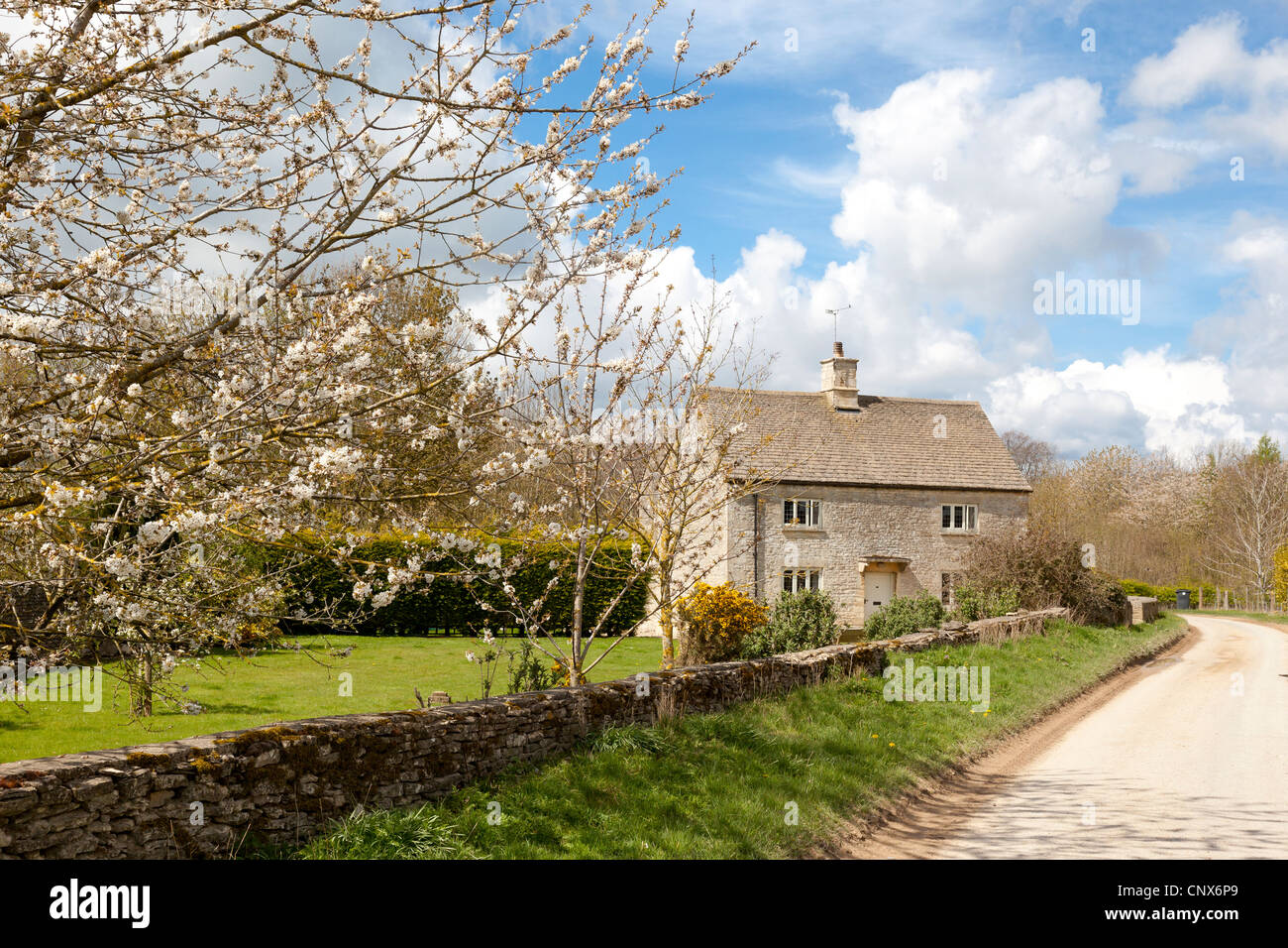 English country farmhouse next to Barrington Park in the Cotswold village of Great Barrington, Gloucestershire Stock Photo