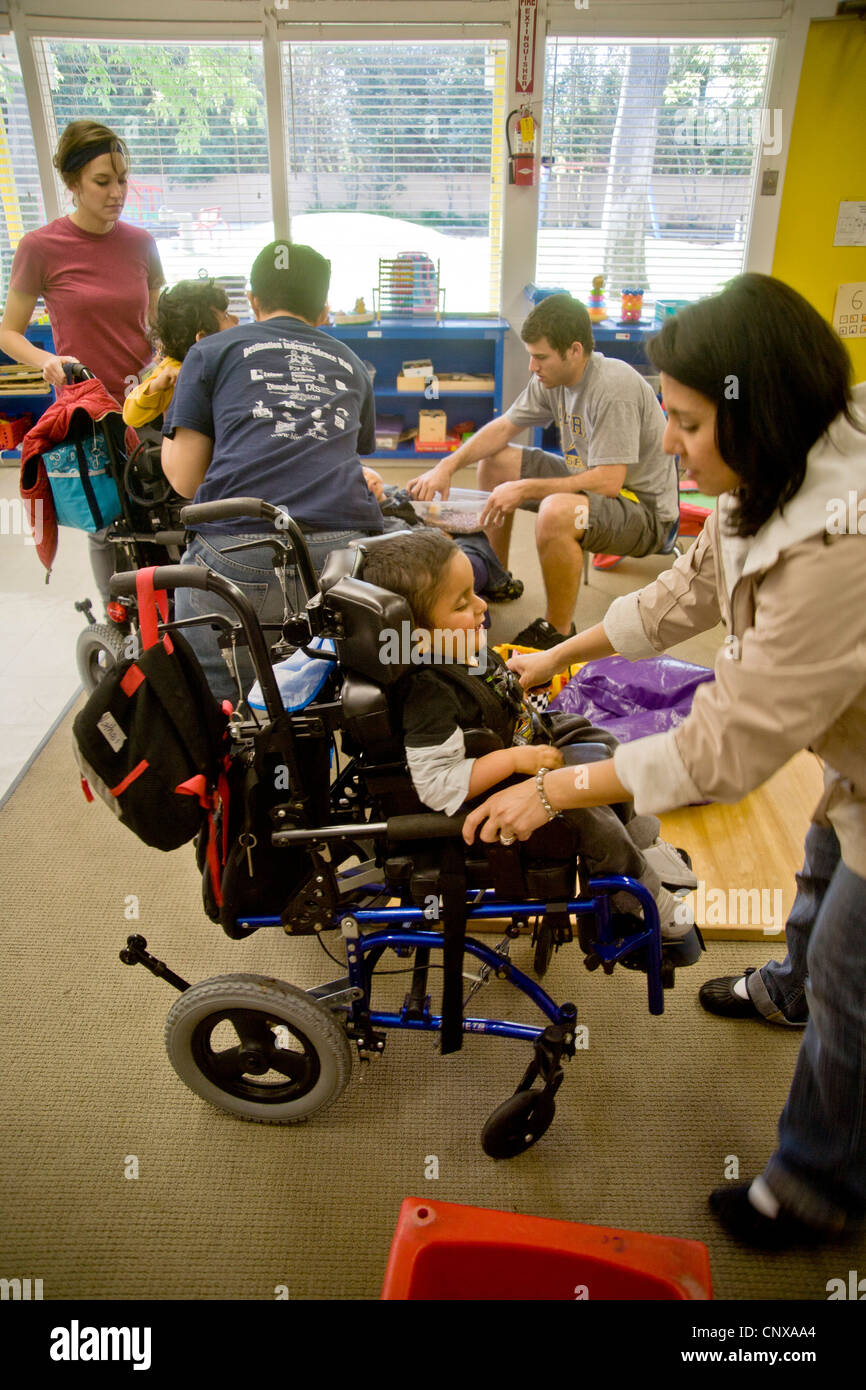 Trained staff members greet arriving blind, visually impaired, and handicapped children at the Blind Childrens' Learning Center. Stock Photo