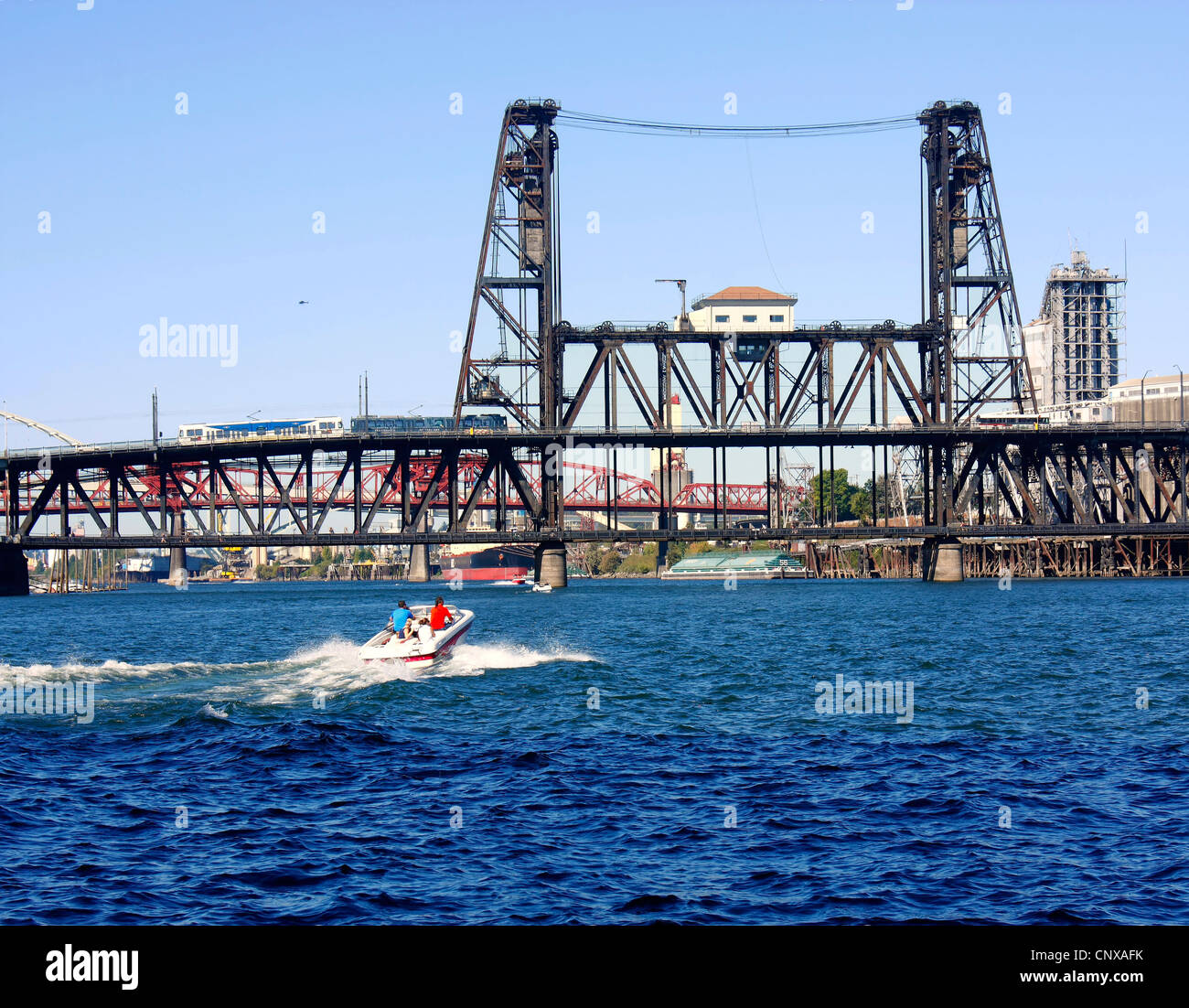 A steel bridge & a power boat Stock Photo Alamy