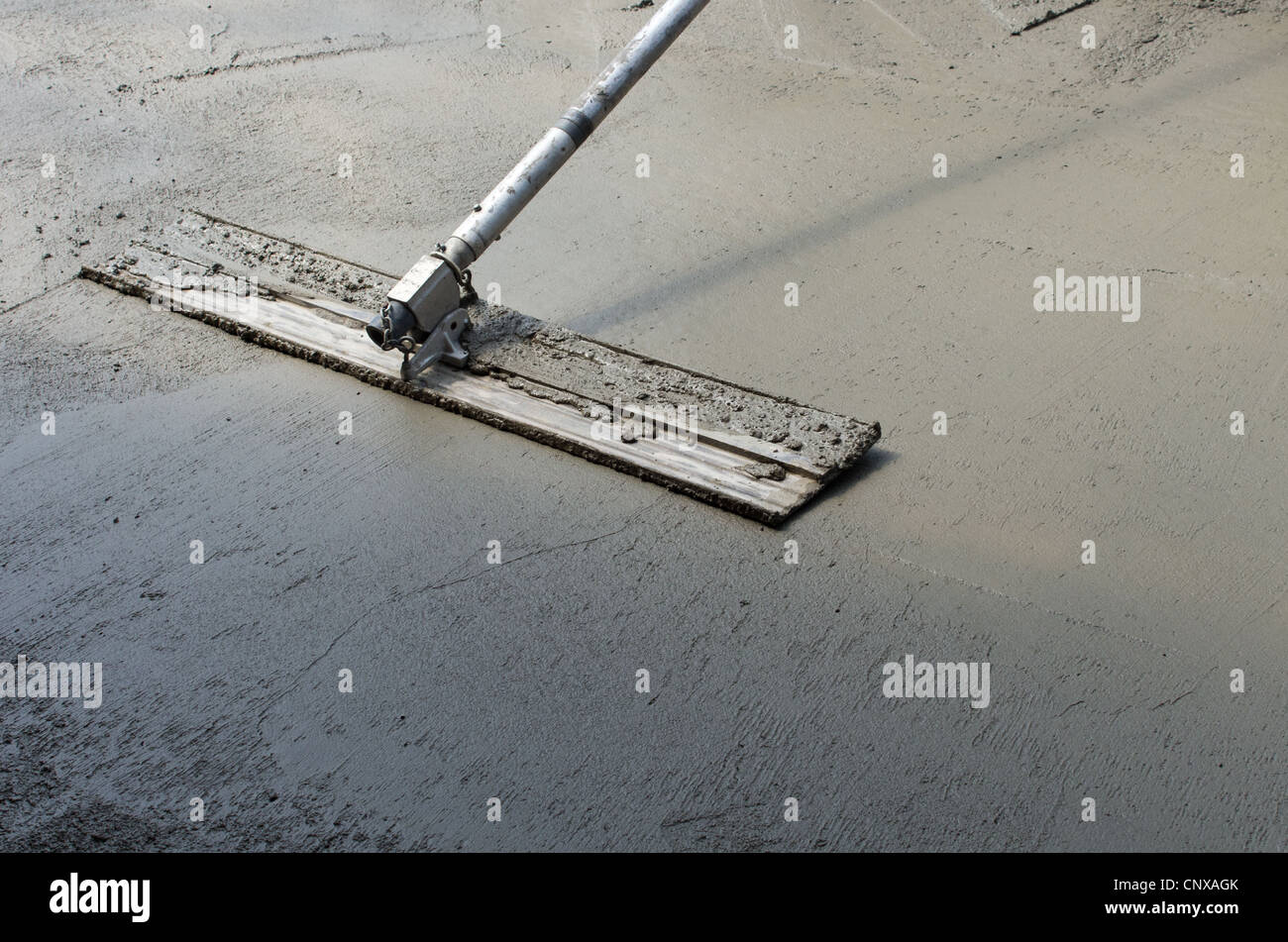 Trowel or float used to finish a concrete floor Stock Photo Alamy