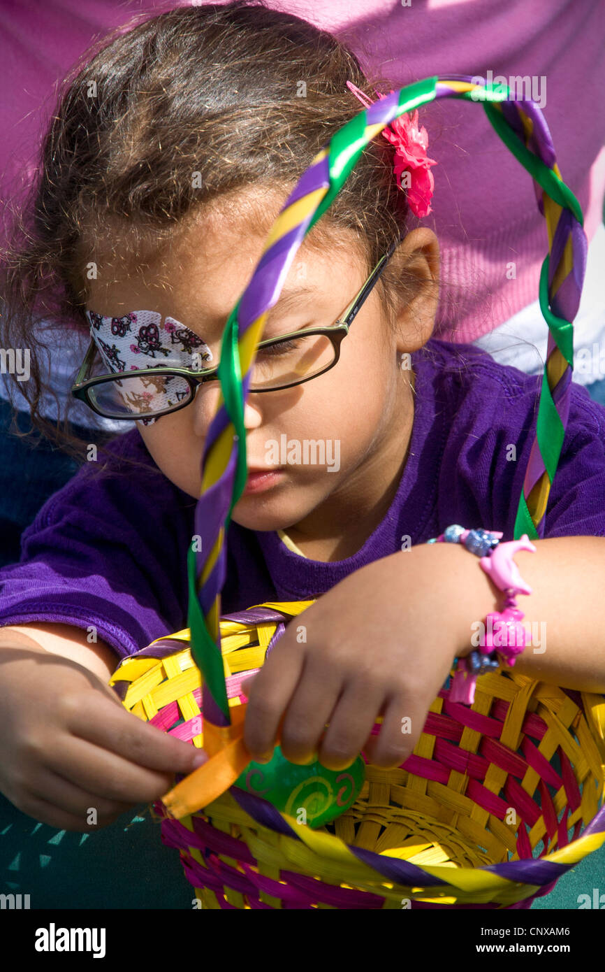 A visually impaired girl decorates a basket at an Easter picnic given by the Blind Children's Learning Center in Santa Ana, CA. Stock Photo