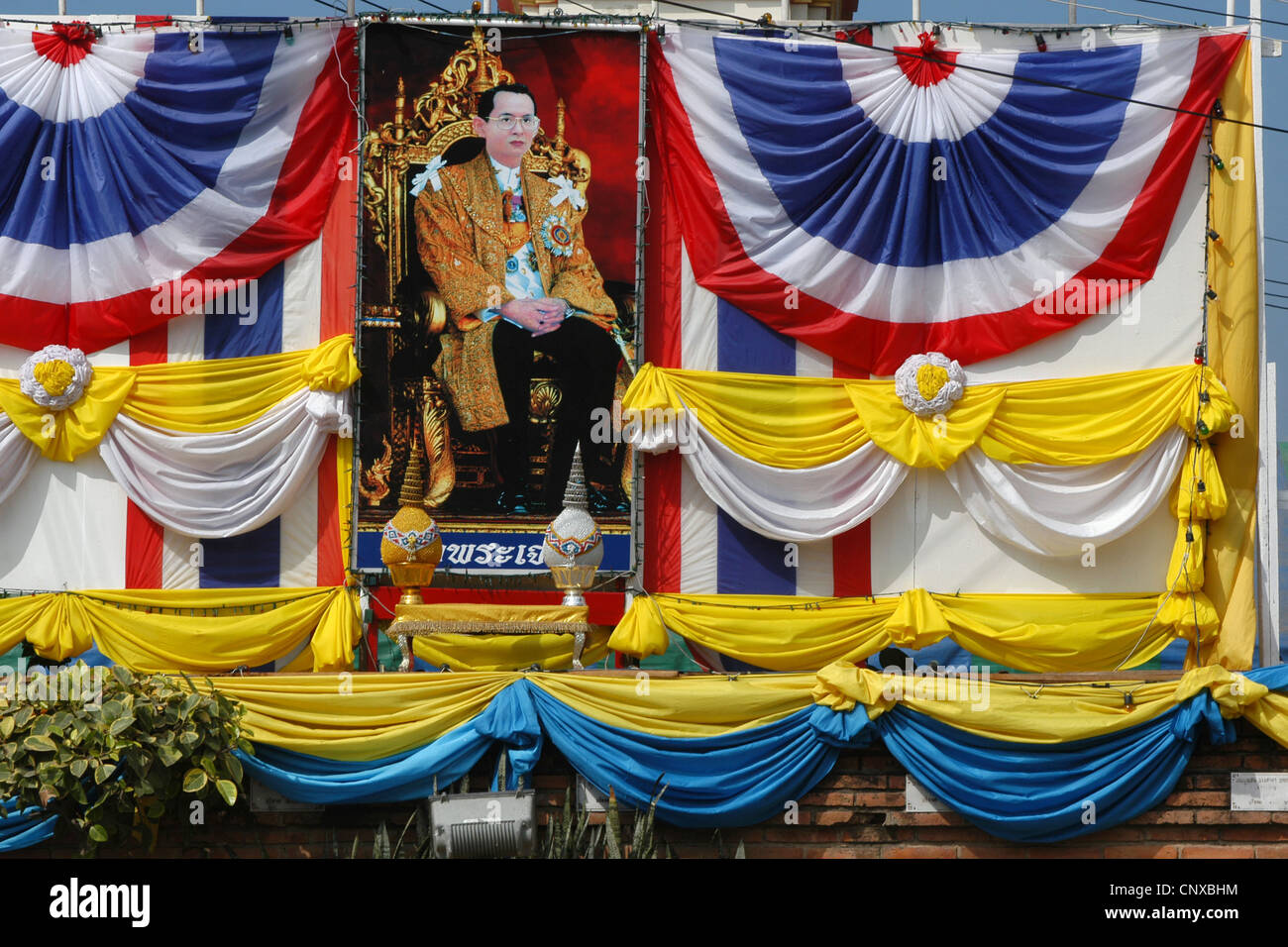 Portrait of King Rama IX of Thailand in front of Wat Na Phra Mane in Ayutthaya, Thailand. Stock Photo