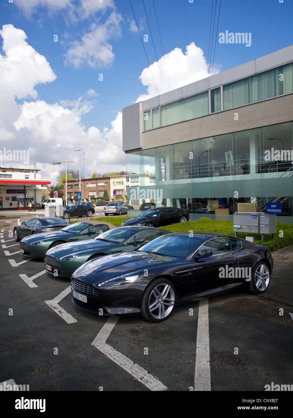 Aston Martin dealership in Antwerp, Belgium, with various models parked out front Stock Photo