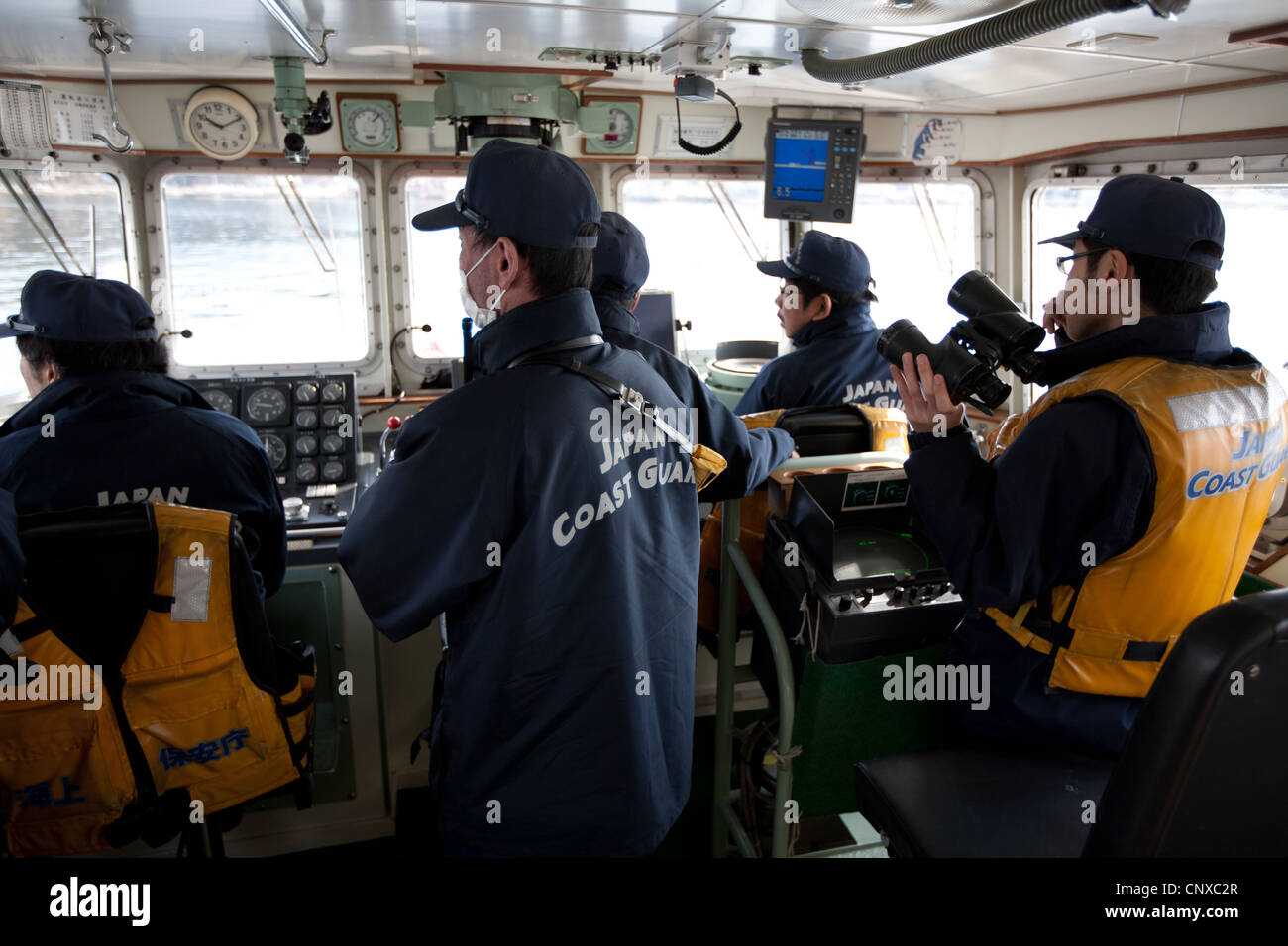 Japanese coast guard search underwater for the bodies of victims of the March2011 tsunami, in Kesennuma harbour, Tohoku, Japan. Stock Photo