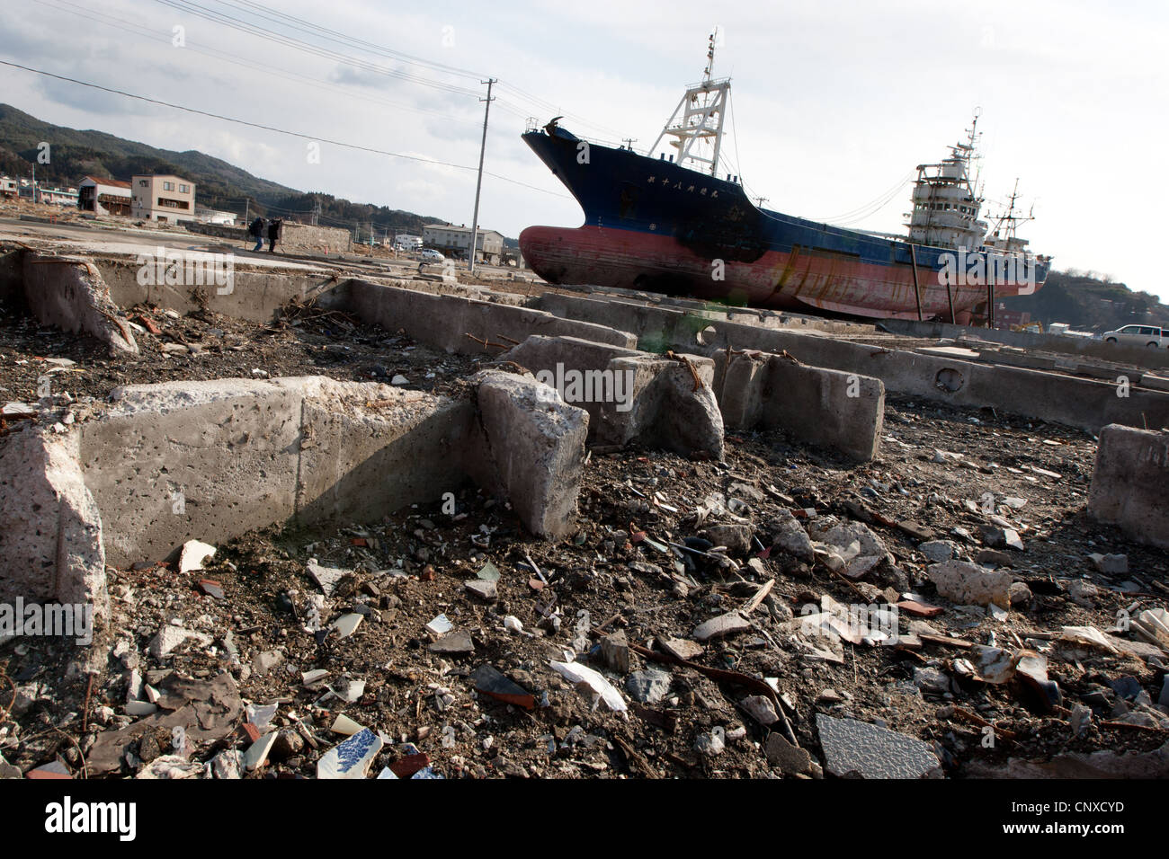 large fishing vessel sits stranded on land, after being carried inland from port by the March2011 tsunami, in Kesennuma, Japan. Stock Photo