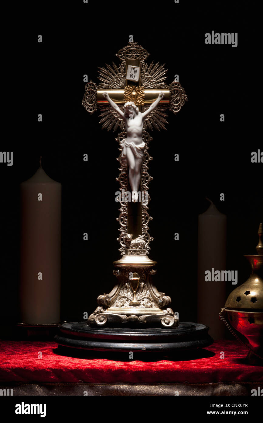 A brass crucifix on an altar Stock Photo