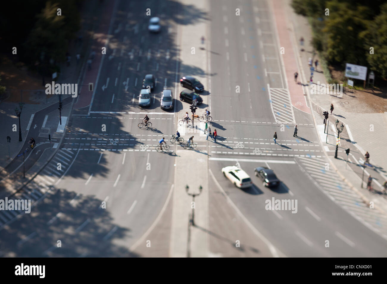 Cars, bicyclists and pedestrians at crossing, tilt-shift, Berlin, Germany Stock Photo