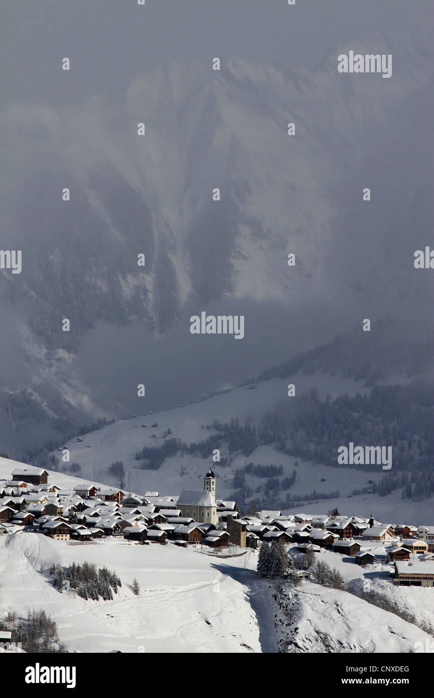 Snowy village with mountain range and valley in the background Stock ...