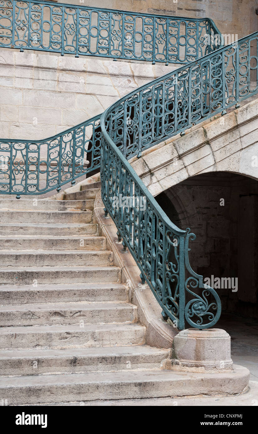 Stone Stair case with wrought iron railings and banisters Stock Photo