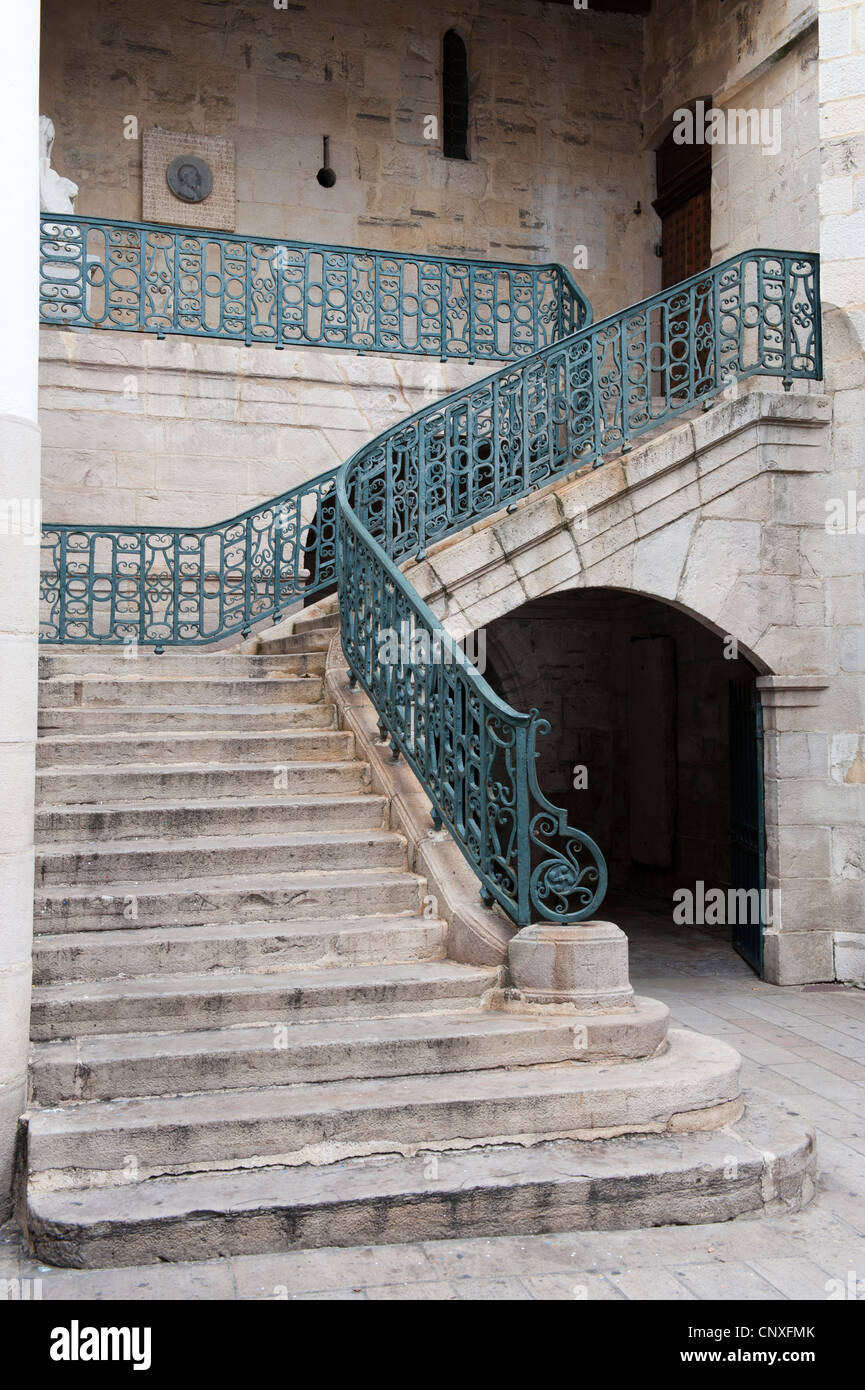 Stone Stair case with wrought iron railings and banisters Stock Photo