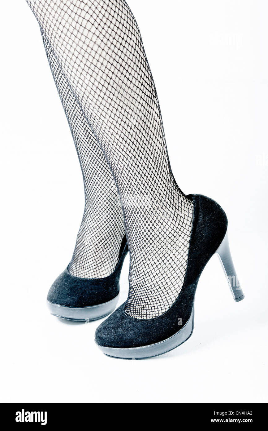 woman with fishnet stockings and shoes with high heels Stock Photo