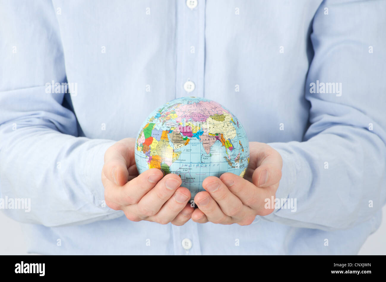 Hands holdings a globe on white Stock Photo