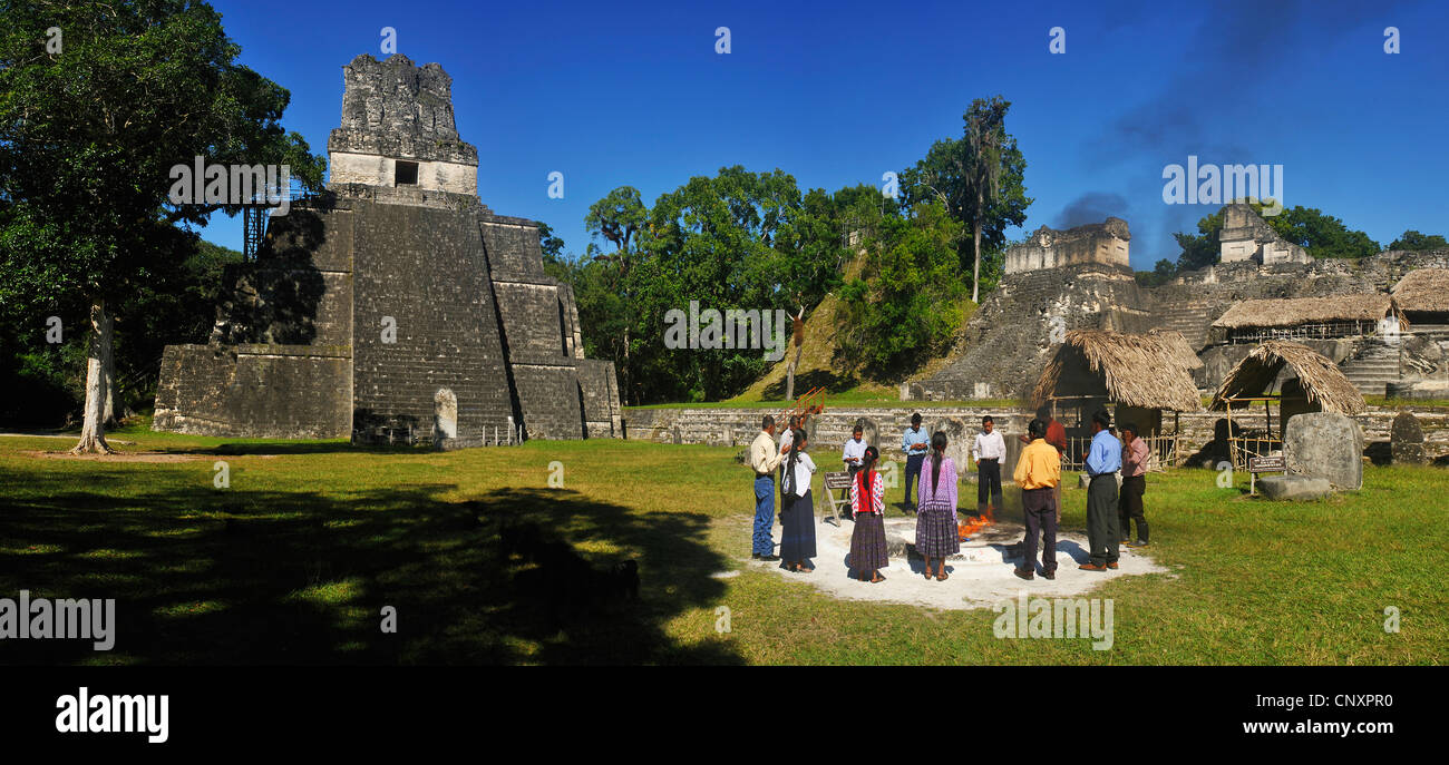 group of peole at a shamanic rite at the main square in front of the pyramid at the main square of the Maya city Tikal, Guatemala, Tikal Stock Photo