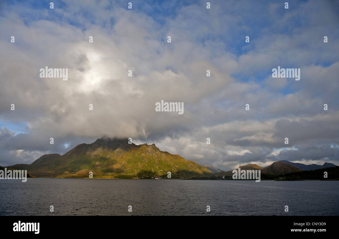 view from the sea to coastline and mountain Tindstind, Norway, Norland, Tinden Stock Photo