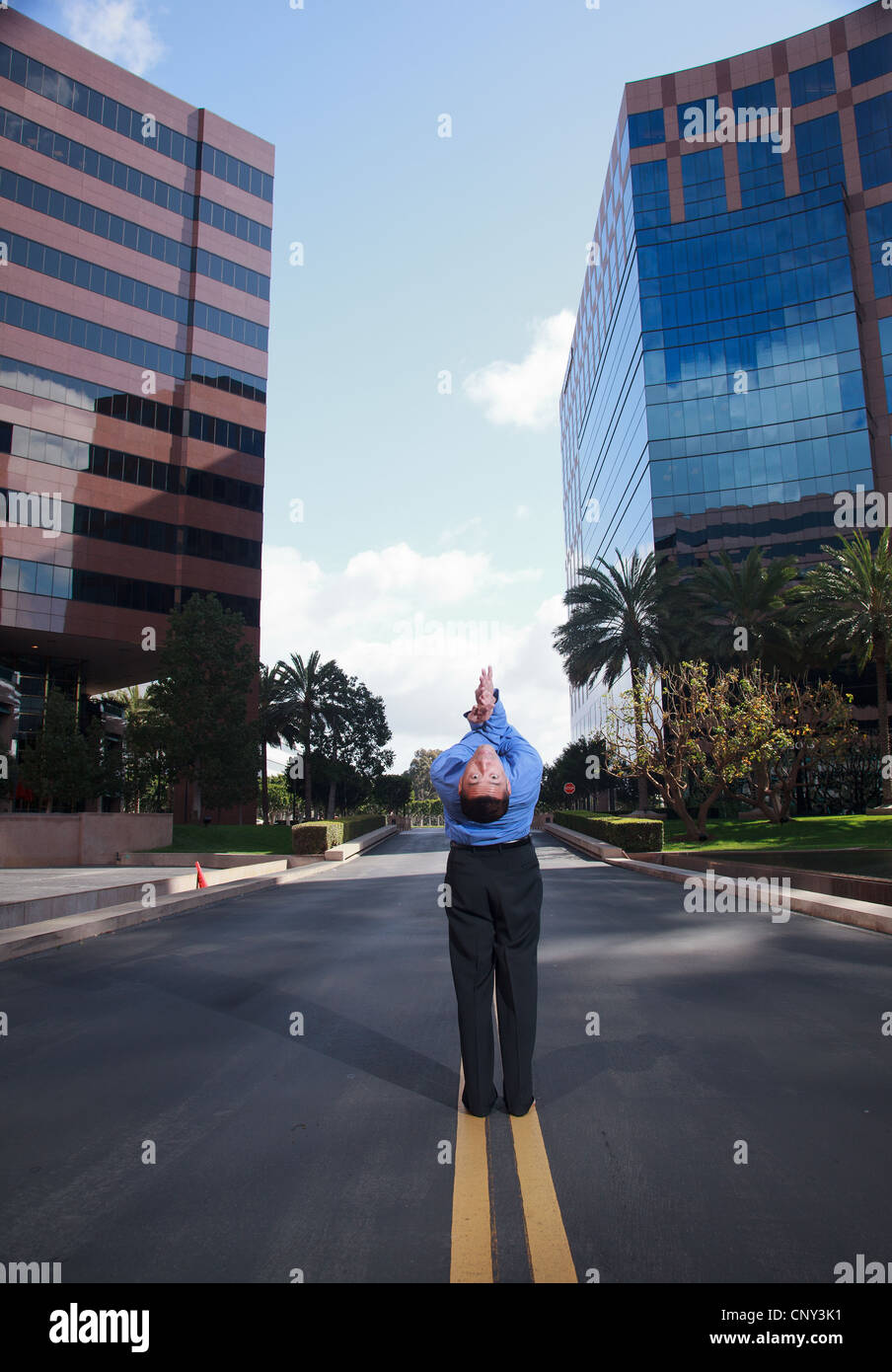 Businessman practicing yoga and meditation in business park with high ... - High Rise Buildings With Yoga And Meditation Classes On Site