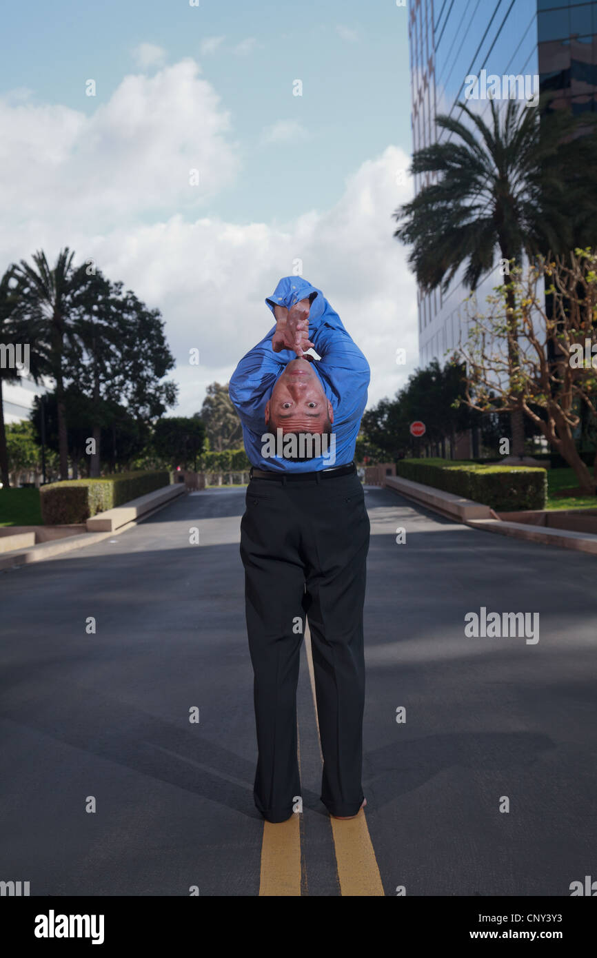 Businessman practicing yoga and meditation in business park with high ...