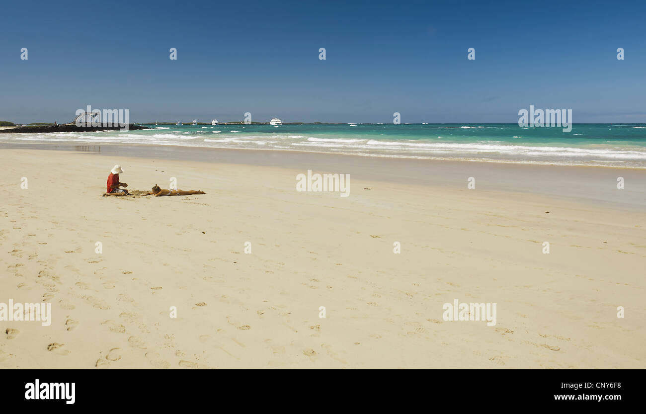 two people at tropical beach, Ecuador, Galapagos Islands, Isabela, Puerto Villamil Stock Photo