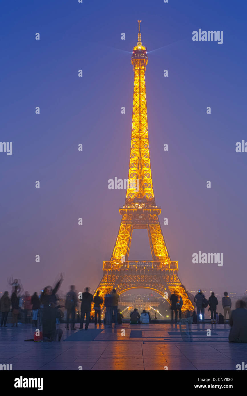 A beam of light from the Eiffel Tower invites visitors to sit and enjoy the show from the Esplanade du Trocadero Stock Photo