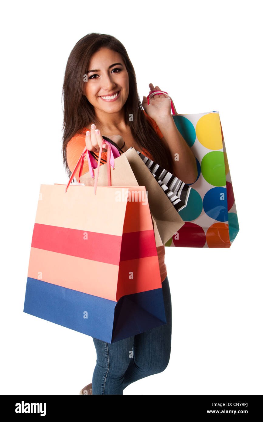 Beautiful Happy smiling young woman on shopping spree carrying colorful bags with merchandise, isolated. Stock Photo