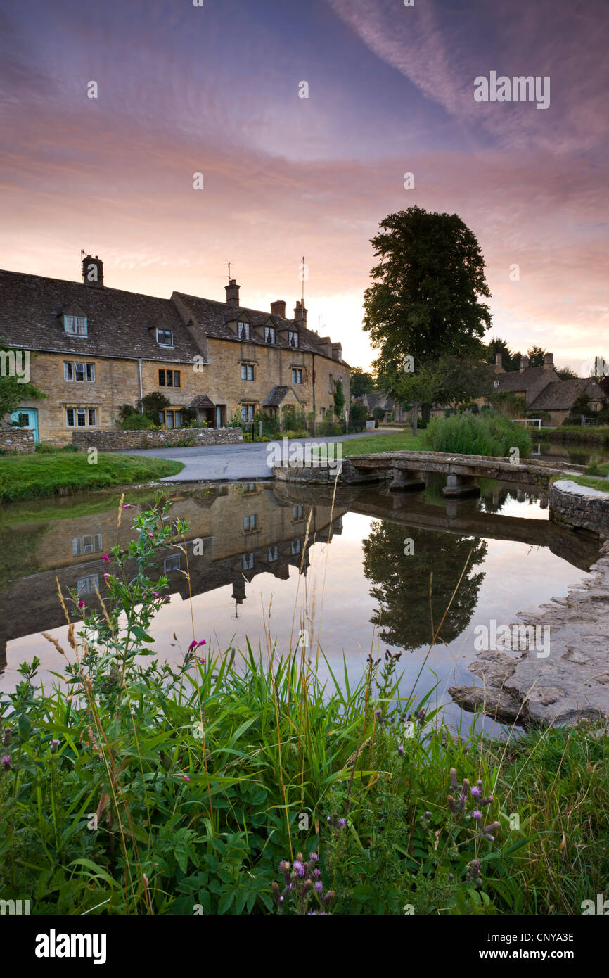 Cottages in the picturesque Cotswolds village of Lower Slaughter at sunrise, Gloucestershire, England. Summer 2011 Stock Photo
