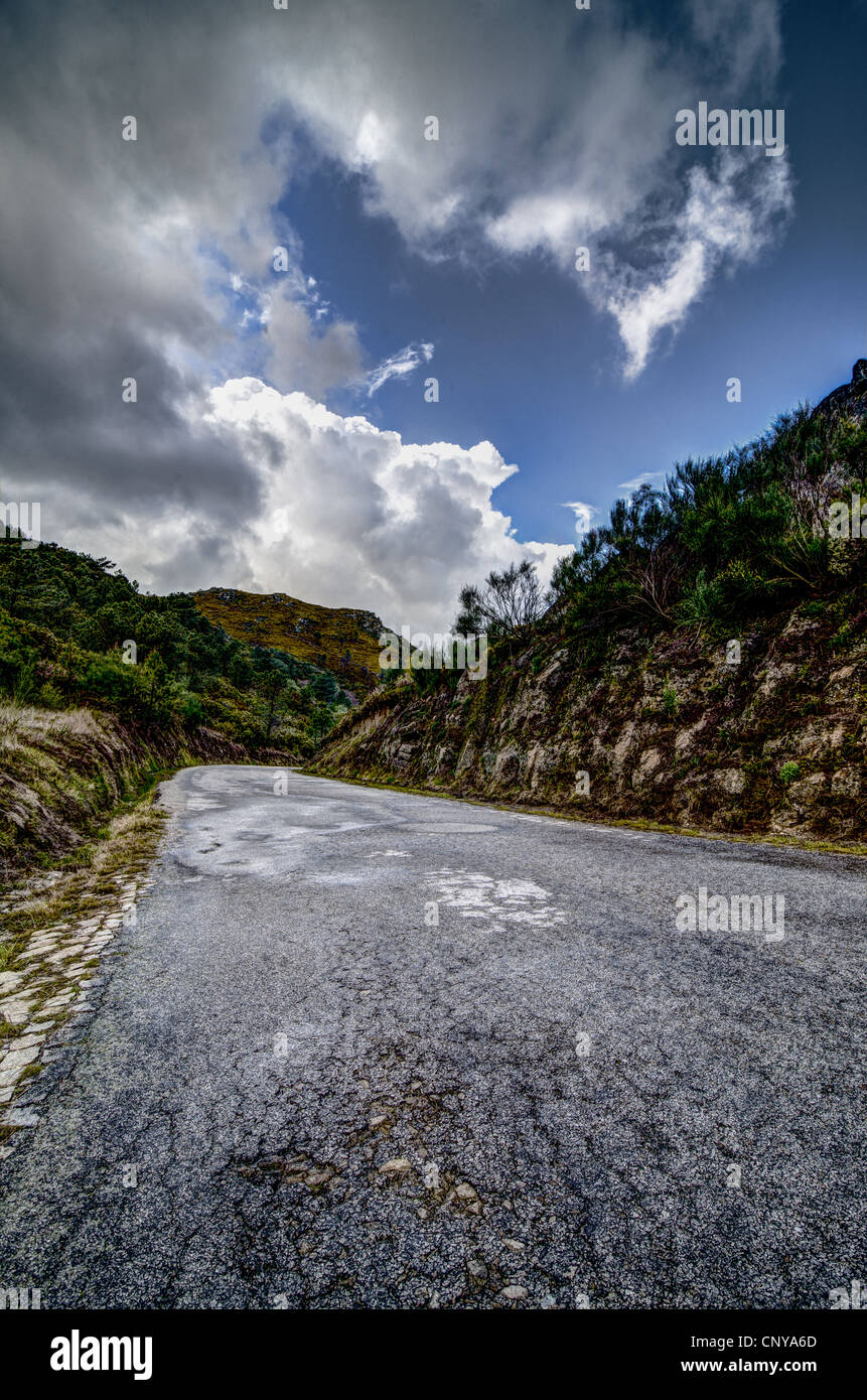 Asphalt road in the mountains and blue sky with clouds Stock Photo - Alamy