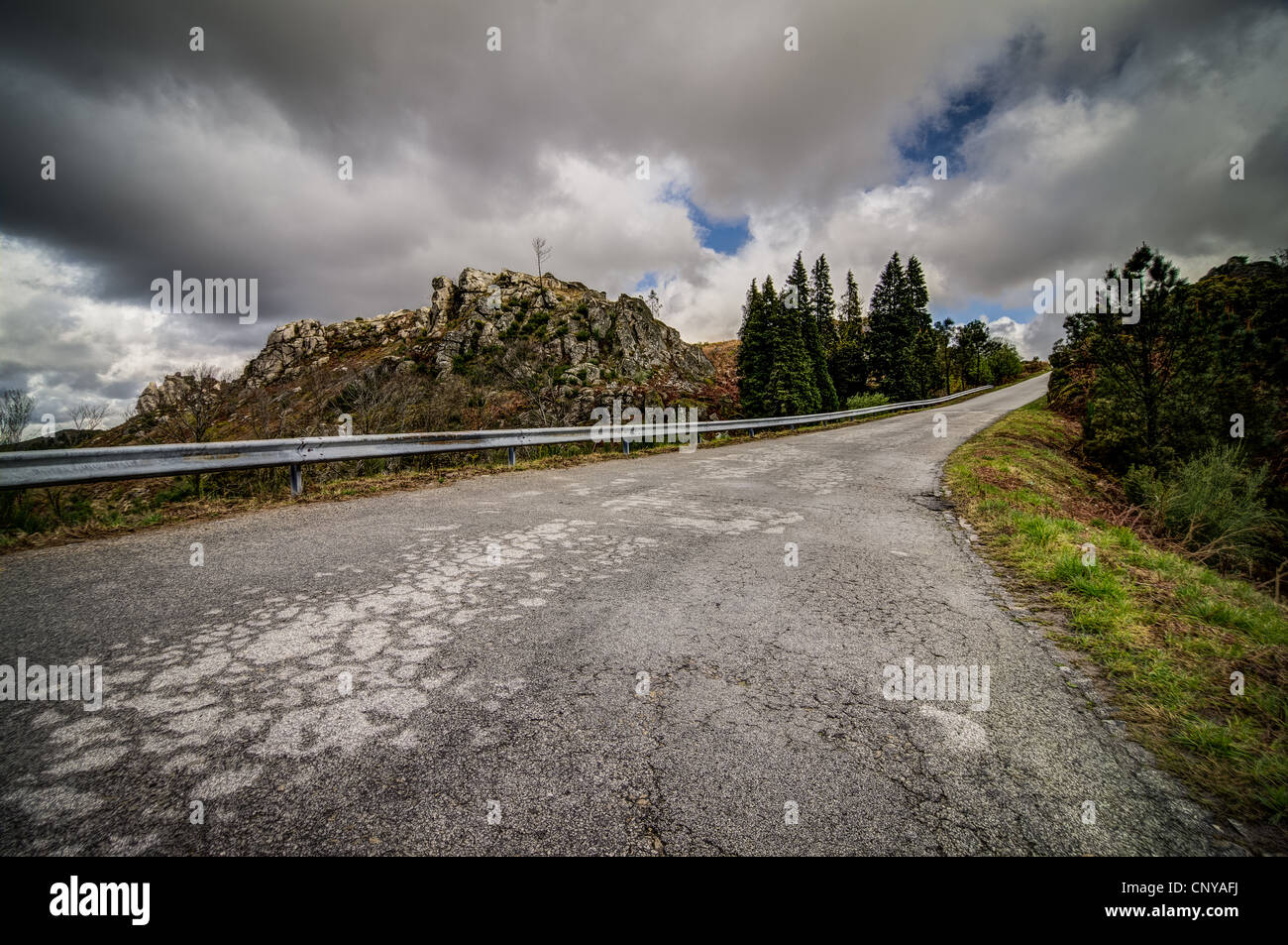 Asphalt road in the mountains and blue sky with clouds Stock Photo - Alamy