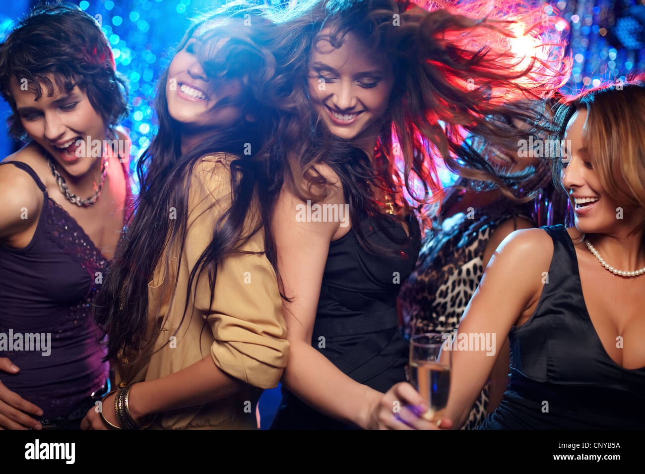 Young women having fun dancing at nightclub Stock Photo