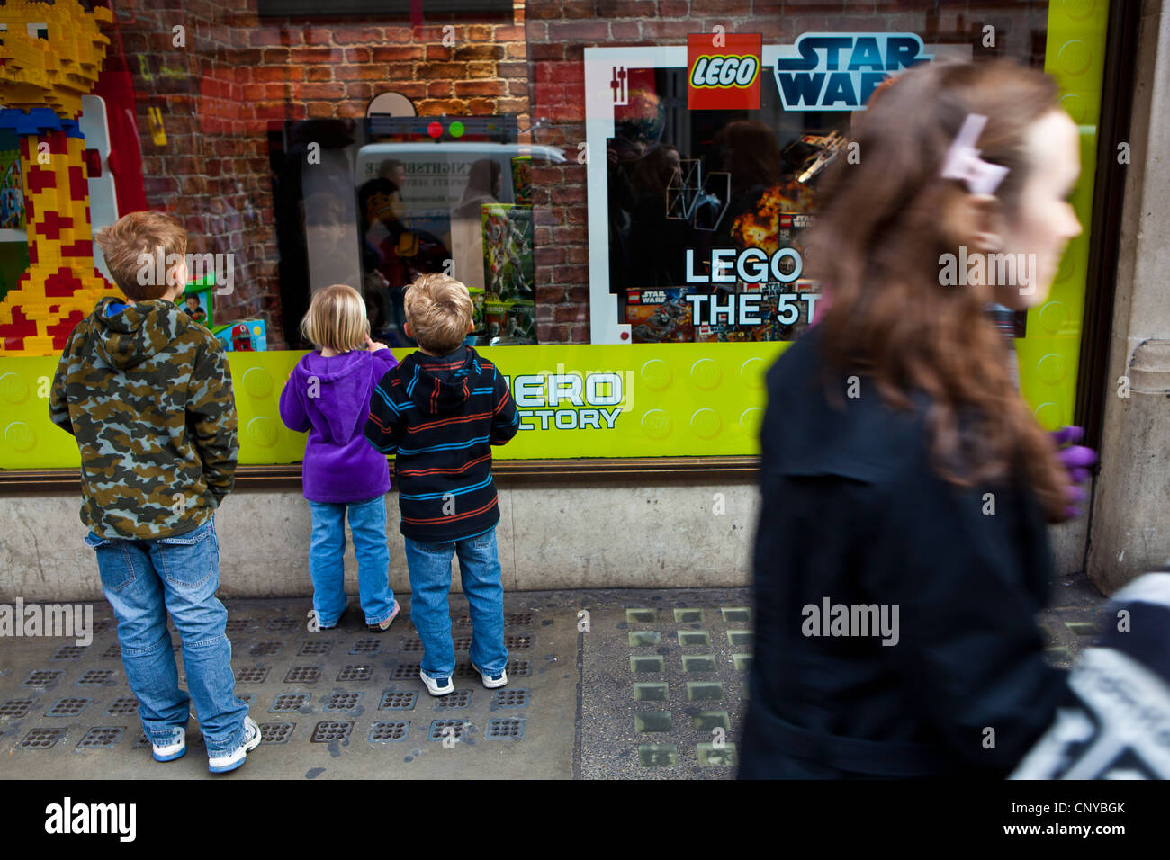 Three boys looking in Hamleys Toy Shop Window. Stock Photo