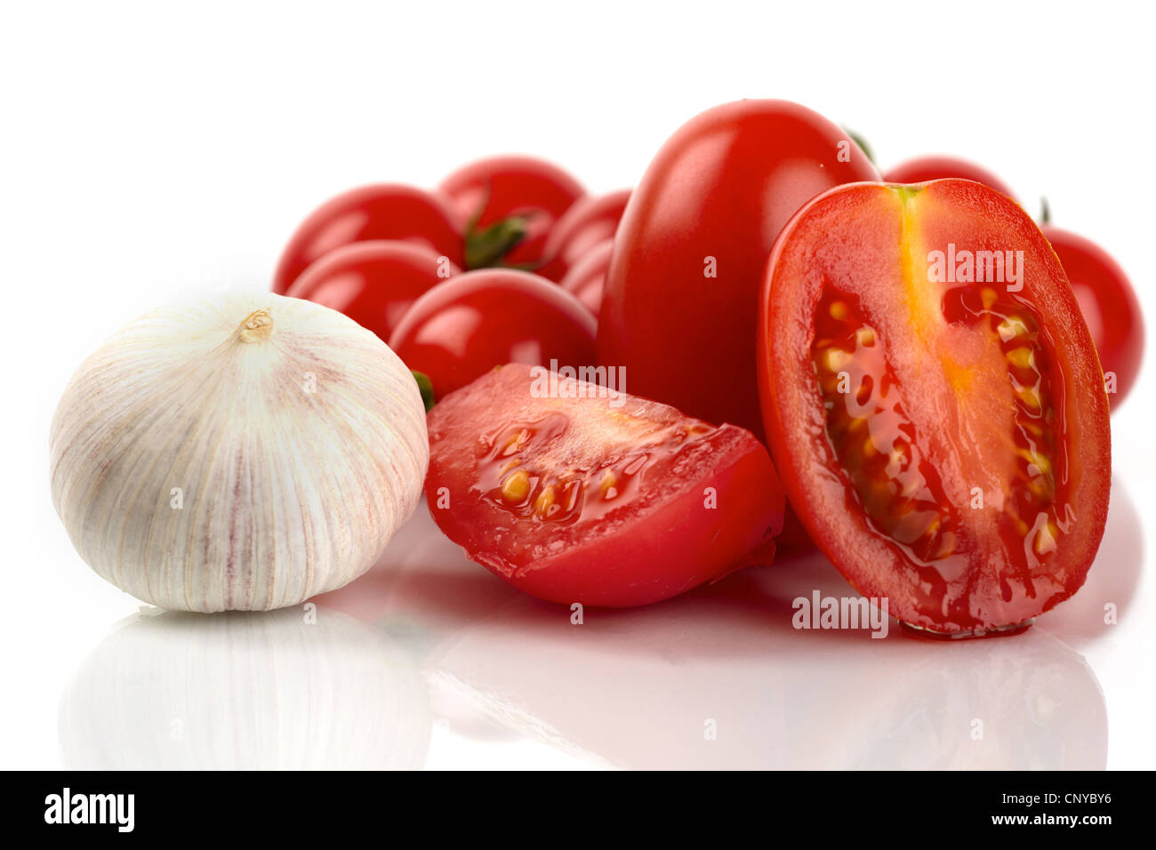 Fresh tomatoes with garlic onion on a white background Stock Photo - Alamy
