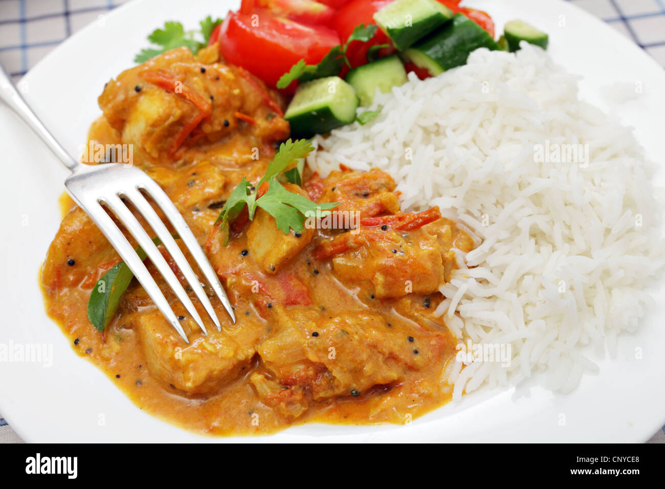 A Kerala or South Indian chicken curry, which includes tomatoes and coconut milk garnished with