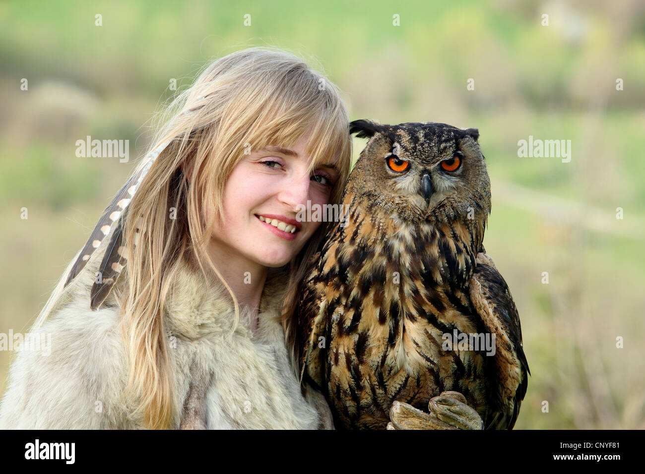 northern eagle owl (Bubo bubo), on the arm of a young woman Stock Photo