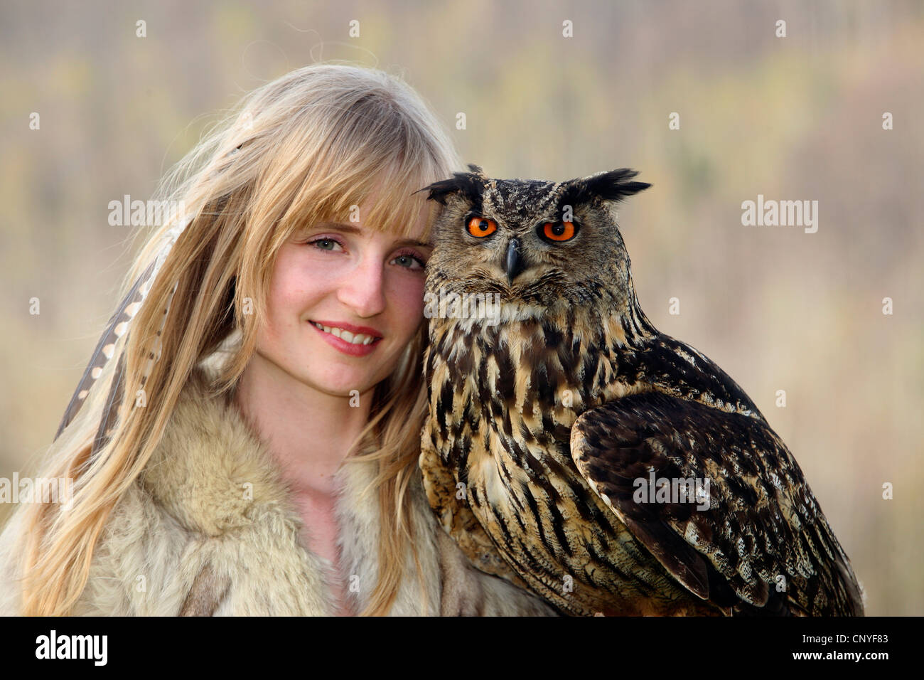 northern eagle owl (Bubo bubo), on the arm of a young woman Stock Photo