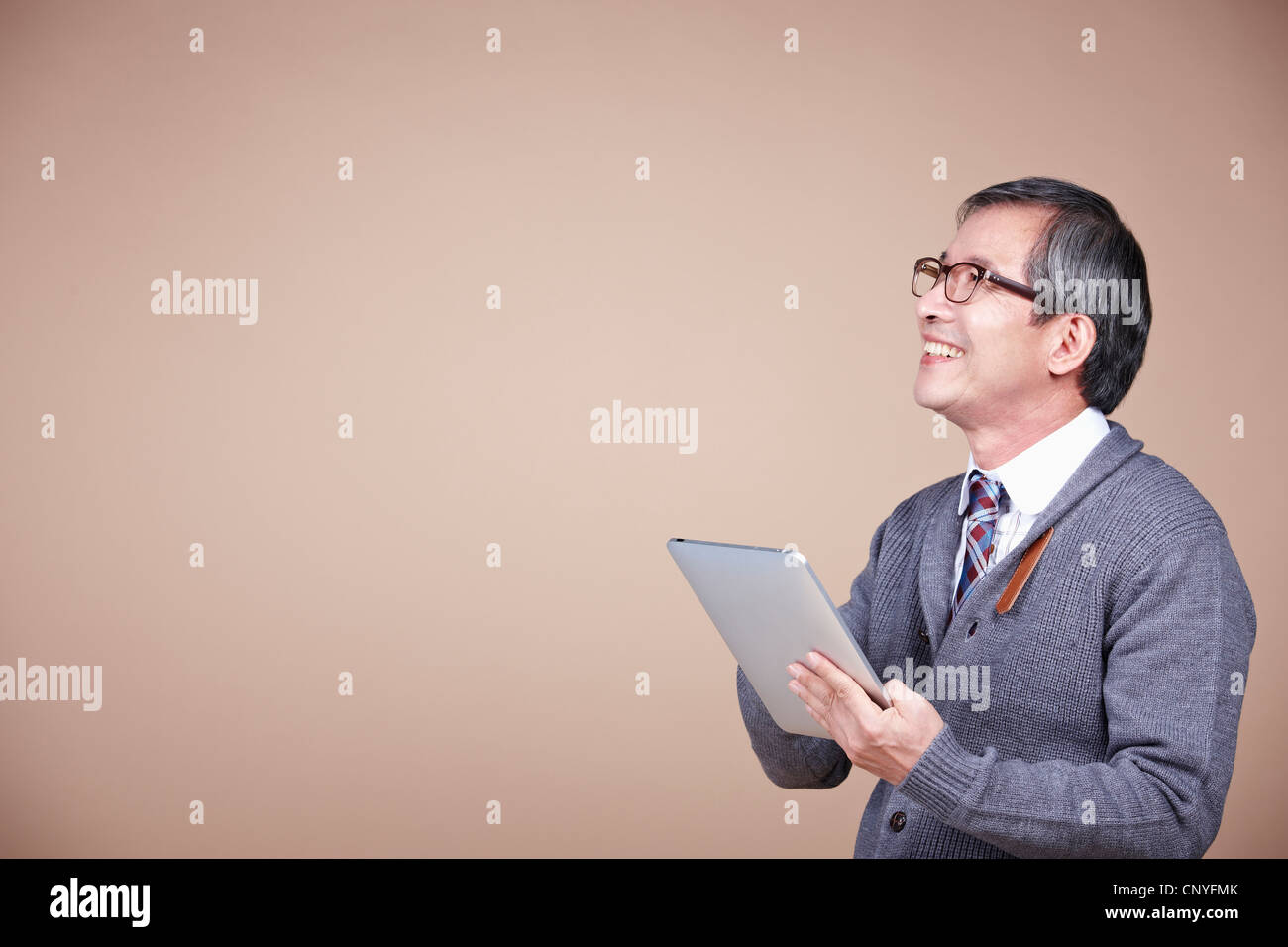 A smiling old man with tablet PC Stock Photo - Alamy