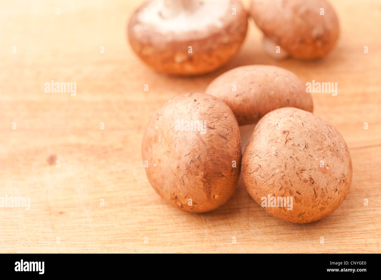 Chestnut mushrooms on a cutting board Stock Photo