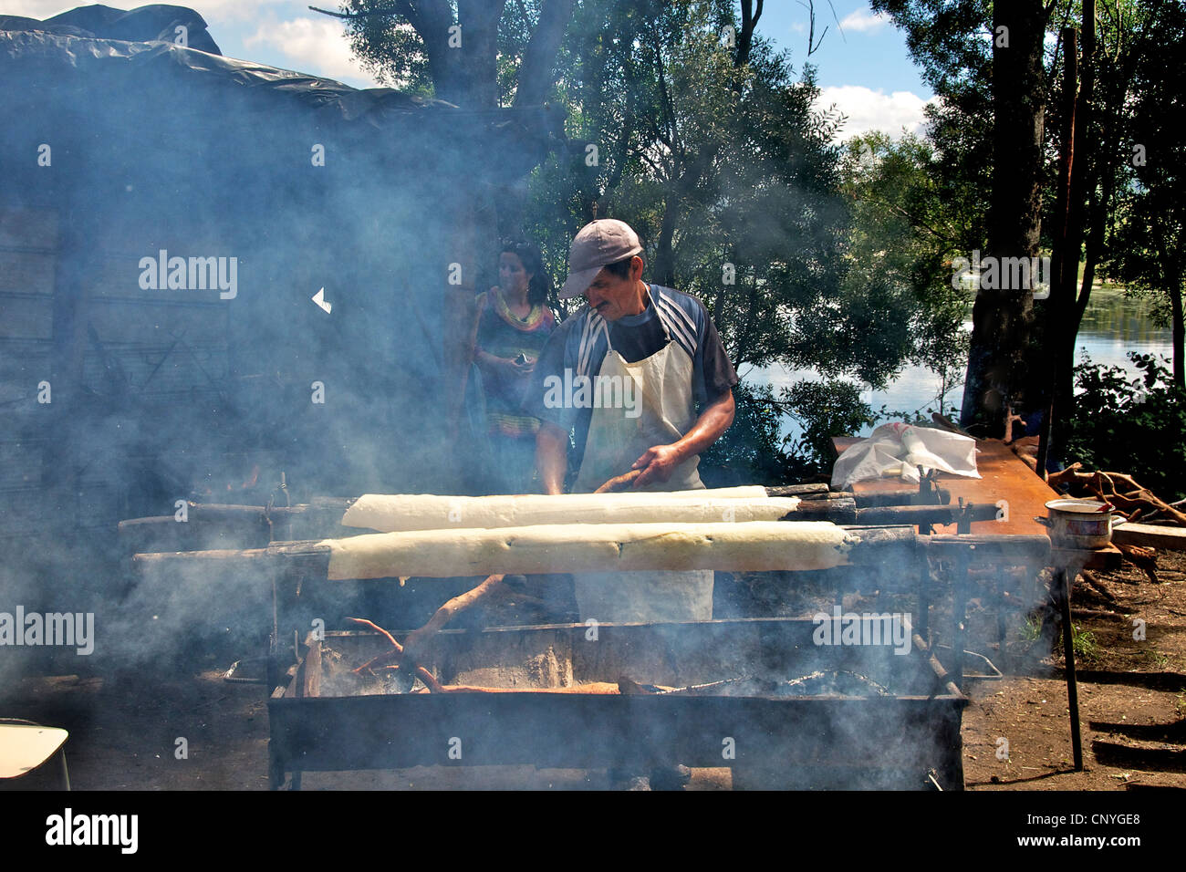 Man baking flat bread Curaco de Velez Chiloe Chile Stock Photo