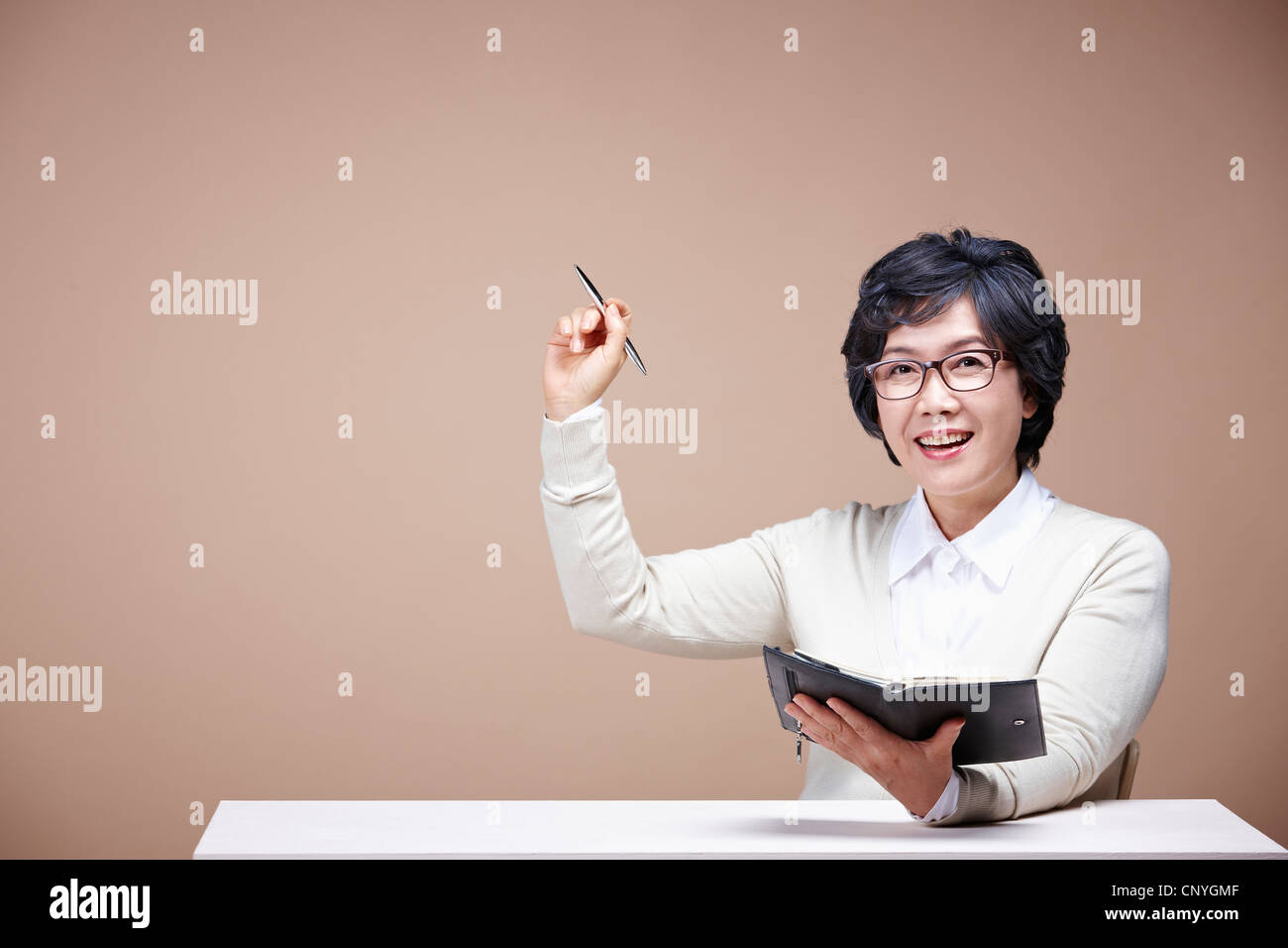 Holding pen mature woman hi-res stock photography and images - Alamy