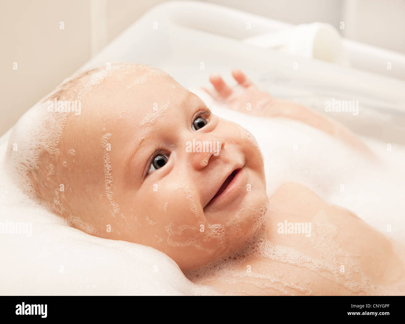 Little baby taking bath, ﻿closeup portrait of smiling boy, health care