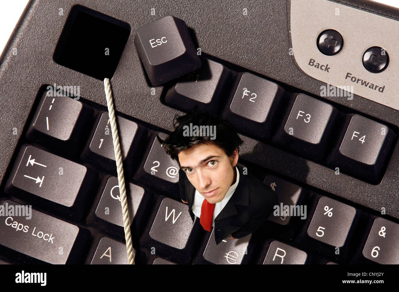 Businessman out of the Escape key in a computer keyboard Stock Photo