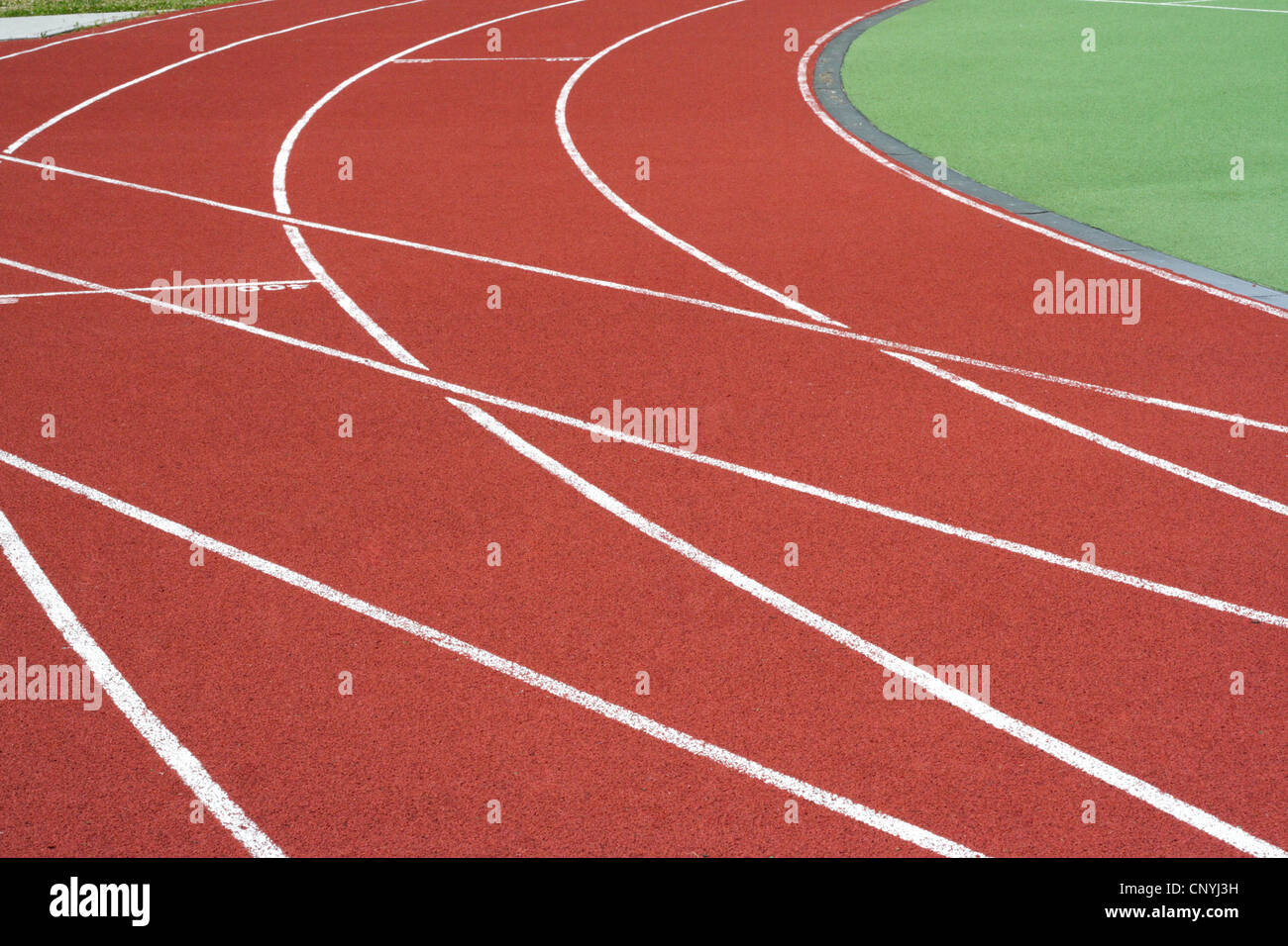 Red tartan athletic track on the stadium Stock Photo - Alamy