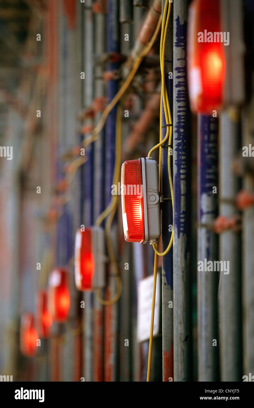 Red marker and warning lights mounted on scaffolding at edge of