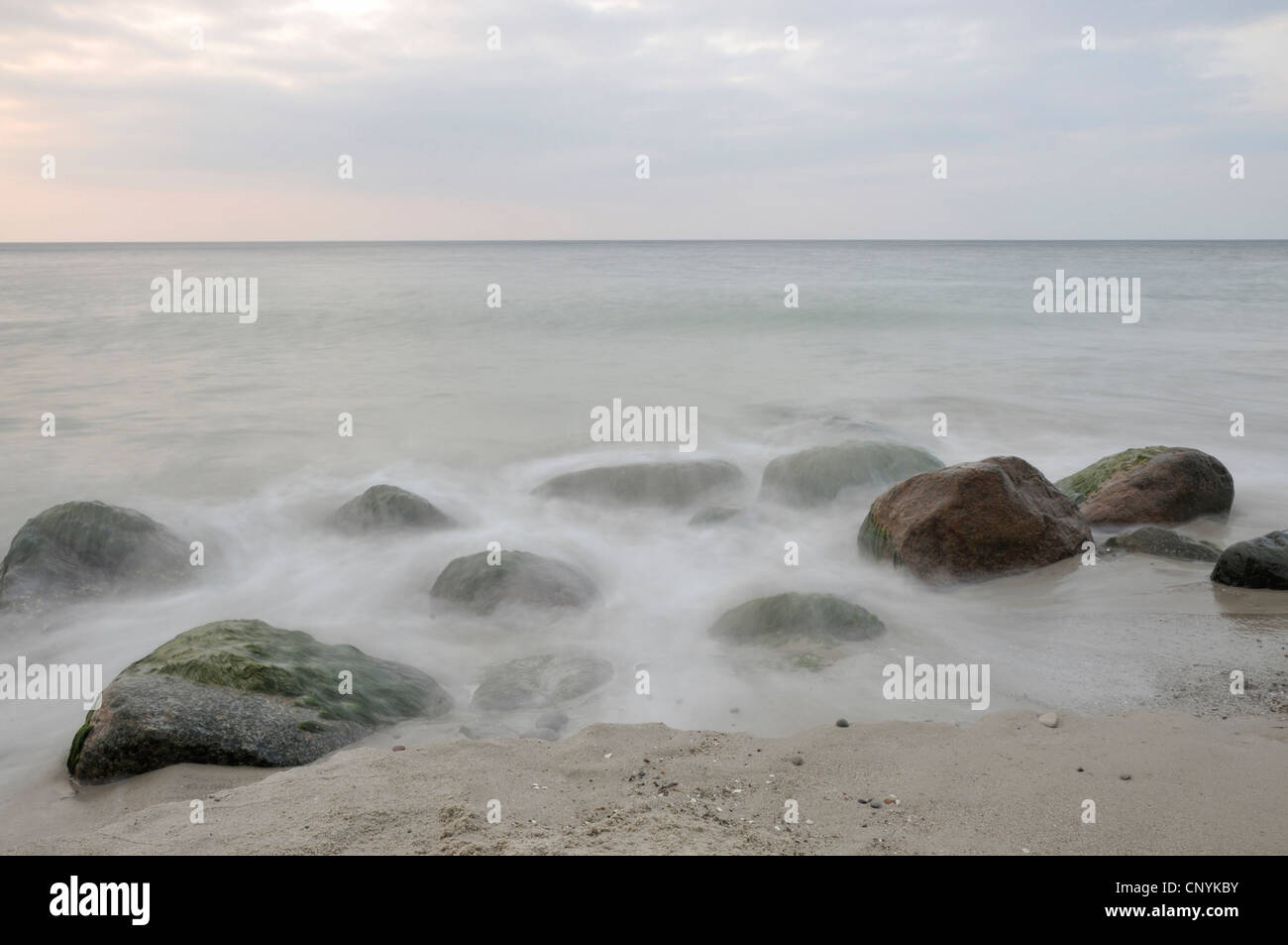 view at the sea over erratic boulders overflown by the surf, Germany, Mecklenburg Vorpommern Stock Photo