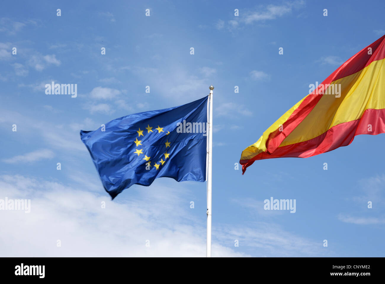European flag and Spanish waving. Stock Photo